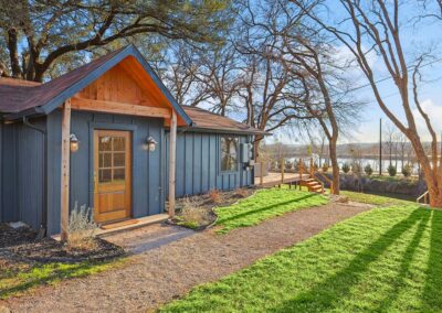 Front view of The Granbury Getaway vacation home with clean landscaping and charming entryway