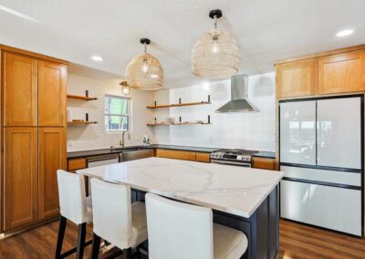 Fully stocked kitchen with modern appliances and dining table for six