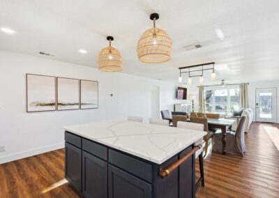 Cozy open-concept living room with plush sectional, smart TV, and natural light