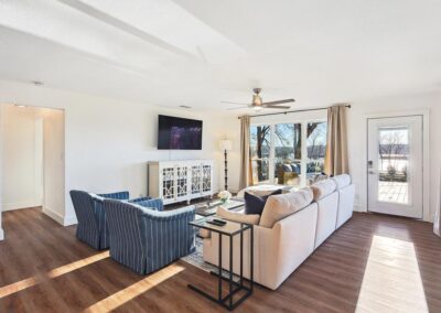 Cozy open-concept living room with plush sectional, smart TV, and natural light