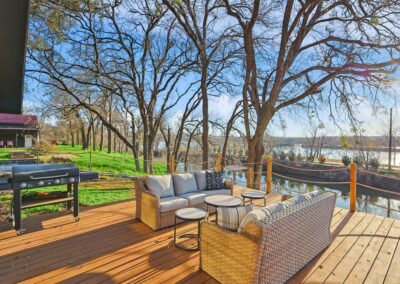 Back view of The Granbury Getaway vacation home with clean landscaping and a great deck for sunset views